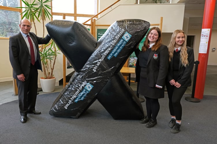 Pictured with Returning Officer Will Bramble are Haverfordwest High students Lucy Ashton and Anna Ford. Lucy and Anna are underlining the importance of young people being registered to vote.