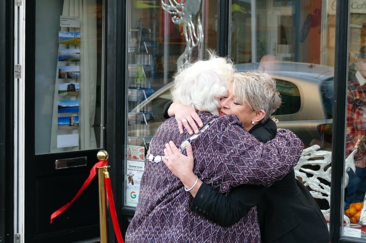 Cllr Pamela George and gallery owner Dawny Tootes hug after the opening of the shop in Dimond Street, Pembroke Dock