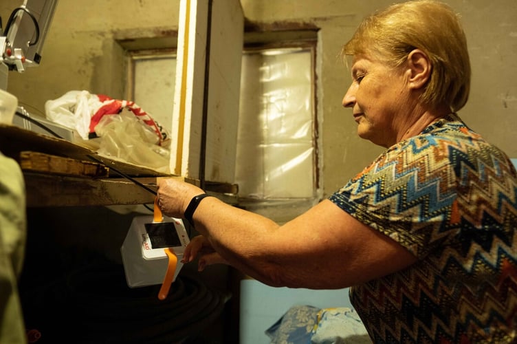 Lyudmyla with a ShelterBox solar light that will help during rolling power blackouts