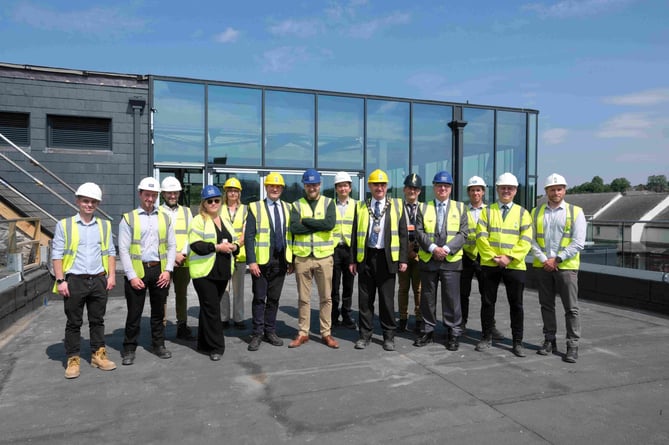 Roof of Quayside development Haverfordwest. Senior Council members, officers and contractors gathered on the roof terrace to celebrate the ‘topping out’ after receiving a tour of the site.