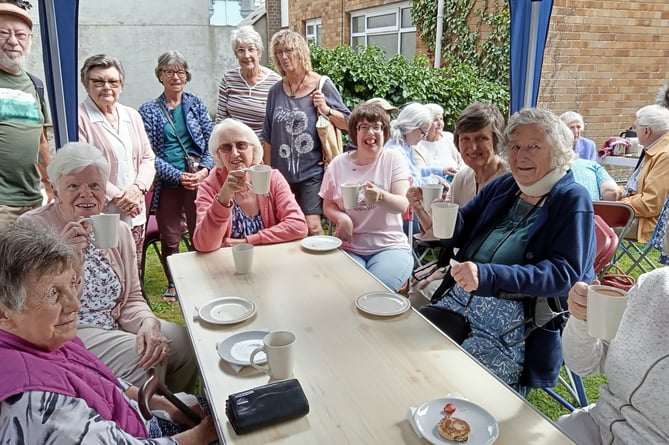 Enjoying tea, scones, jam and cream at the St Johns teddy bear picnic afternoon tea party