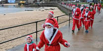 Soggy Santas take to seaside streets of Tenby for festive fundraiser