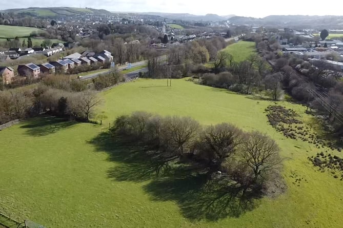 Industrial units are planned at these two fields between the A40 and the railway line (right), west of Carmarthen.