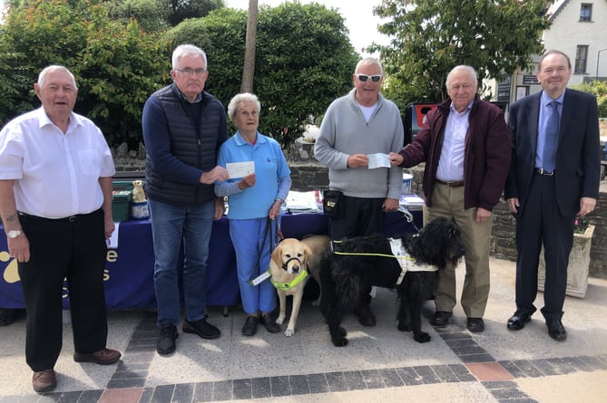 Narberth Masonic Lodge Worshipful Master W. John Mycroft presenting a cheque to Eva Rich, Guide Dogs Cymru Pembrokeshire Branch Organiser with guide dog Nancy; Bro. Mike John presenting a cheque to his brother, Anthony (Adge) John with guide dog Skip; Bros. Richard Fanus and Andrew Walker.