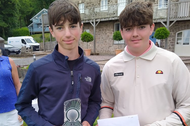 Josh Richards (left) receiving his prize from Junior Captain Liam Bain