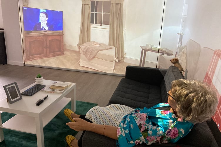 A mannequin resembling an elderly woman watching television at the home simulation suite at Swansea University