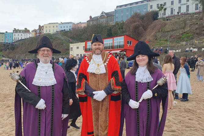 Mayor of Tenby, Cllr Dai Morgan pictured at last year's swim with John Morgan, Sergeant at Arms (now retired); and stand in Mace Bearer Erin Morgan.