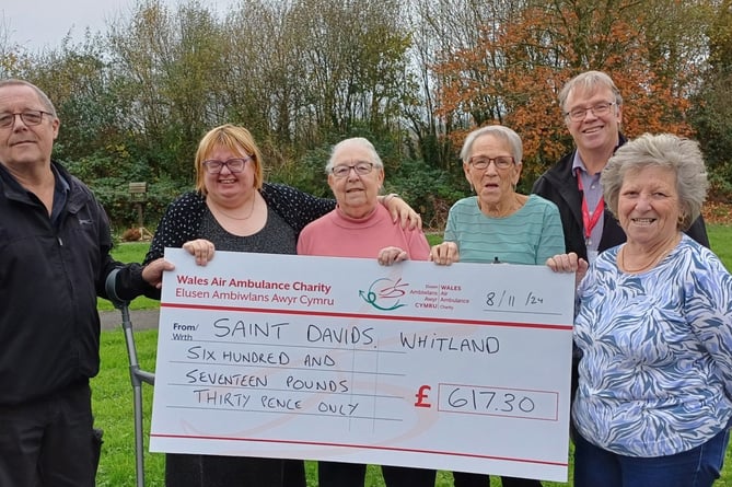 Pictured are residents at St Davids Avenue in Whitland - John, Bobbie, Jocelyn, Wendy, Ann presenting the donation to Regional Fundraising Manager for the Wales Air Ambulance Mike May.