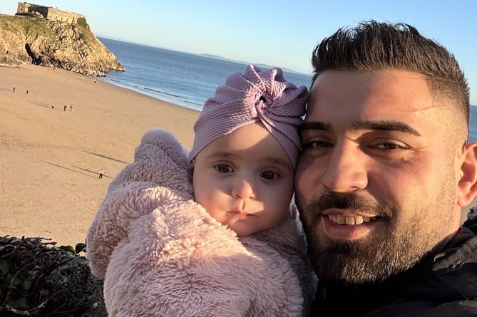 Baby Sophia with her dad pictured in Tenby by Castle Beach