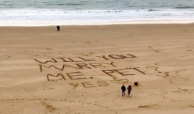 At around 10.45am on January 11, on a blustery morning on Iron Bar Sands, in between Castle and South beaches, Thomas Wooles popped the question to Pettrina Williams, after he had written the words ‘Will You Marry Me, Pet?’ in the sand earlier that morning; before taking his girlfriend back to the spot, where she replied by scribbling ‘Yes’ underneath.